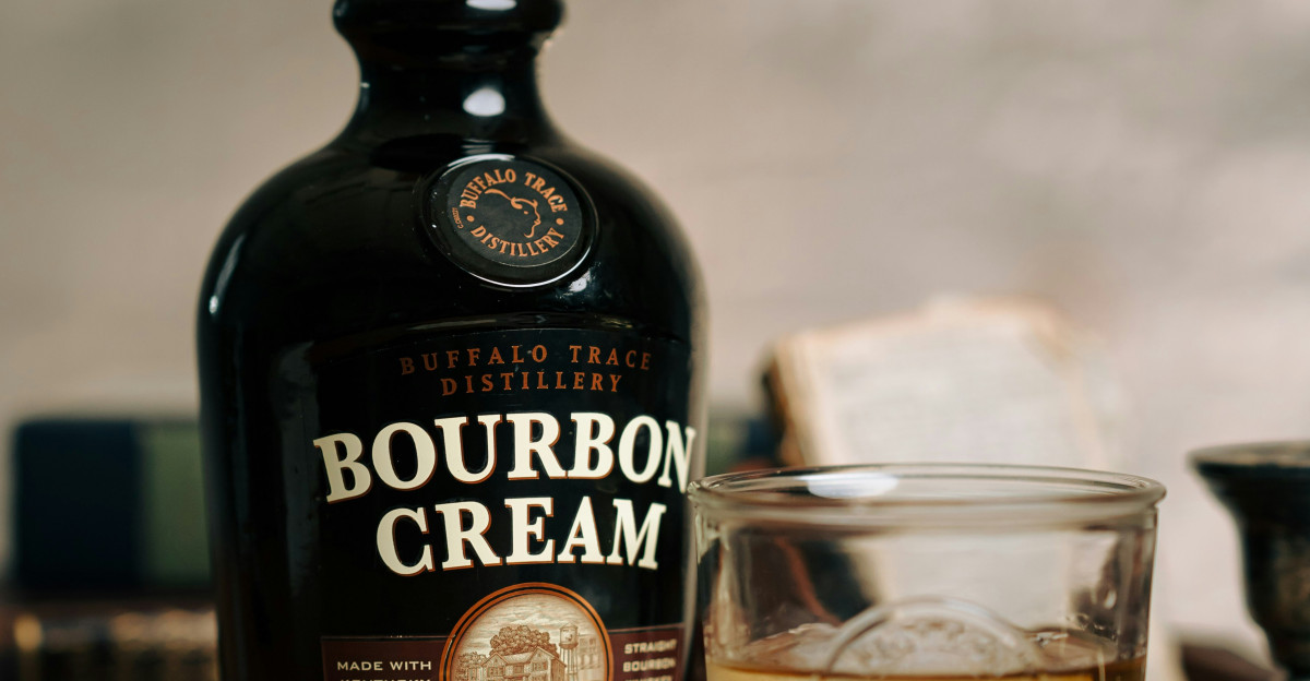 a bottle of bourbon cream next to a glass