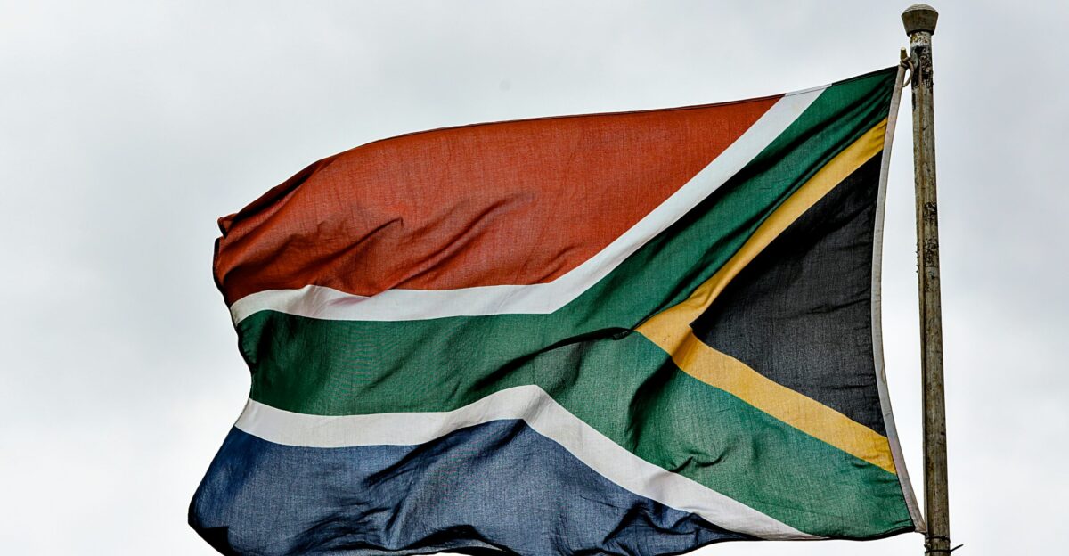 a flag flying in the wind on a cloudy day