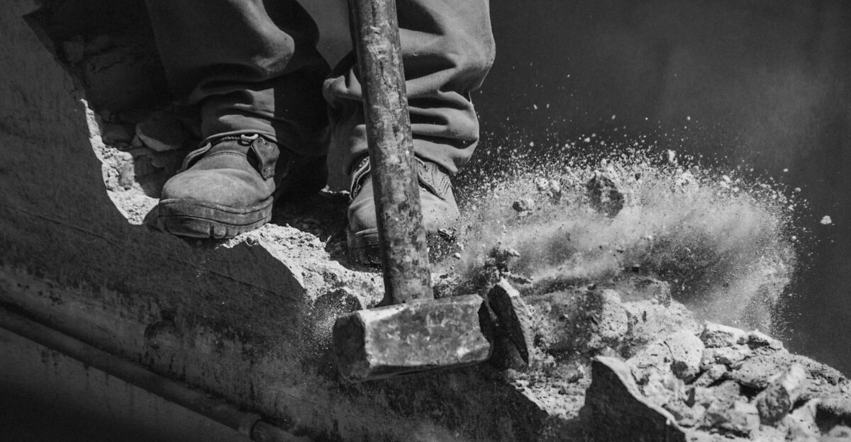 Close-up of worker using a sledgehammer to demolish concrete in Buenos Aires