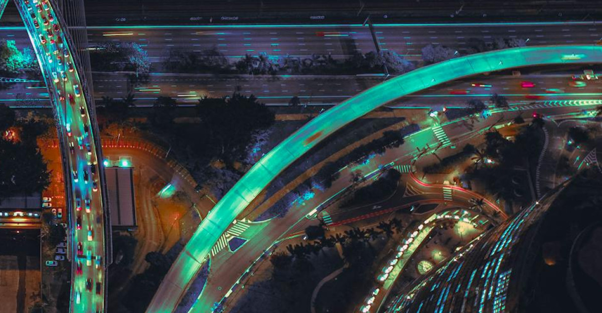 A stunning aerial view of illuminated highways and a cable-stayed bridge at night
