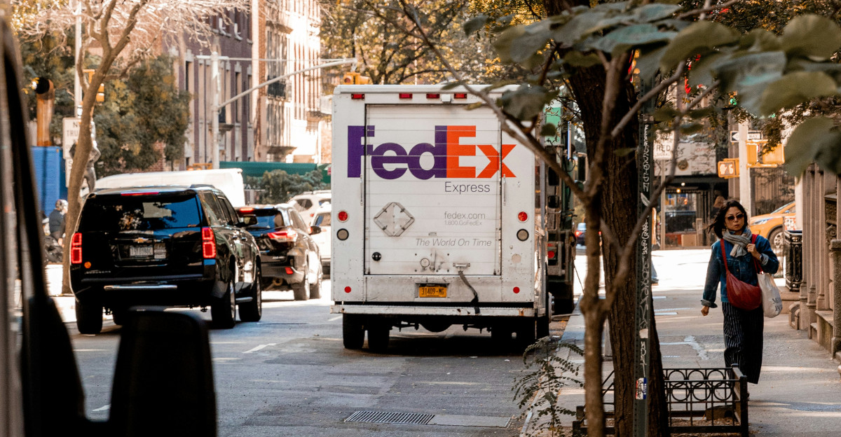 a fed ex truck parked on the side of a street