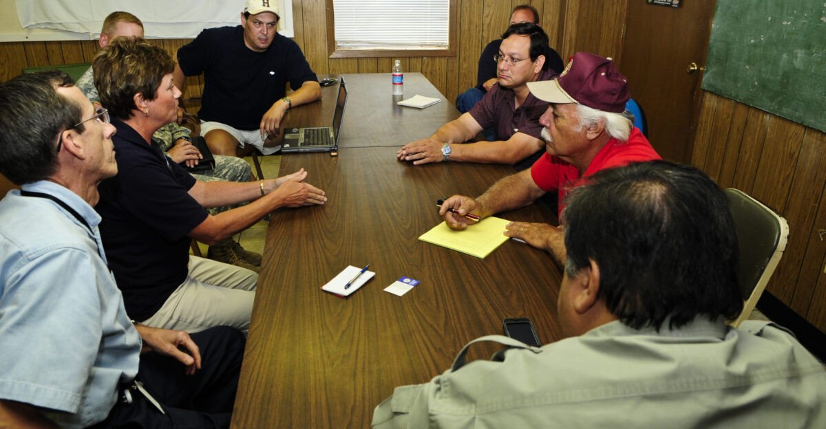Raymondville TX July 26 2008 - FEMA s Sandy Coachman Federal Coordinating Officer FCO second from left - navy blue shirt participates in a meeting with state and local officials during Saturday meetings concerning recovery actions for Hurricane Dolly Visible participants seated L-R Frank Cantu State Coordinating Officer SCO Coachman Elearza Garcia City Manager Frank Torres Willacy County Emergency Management Coordinator Emilo Vera Intrim-County Judge and Orlando Correa Raymondville Mayor Barry Bahler FEMA