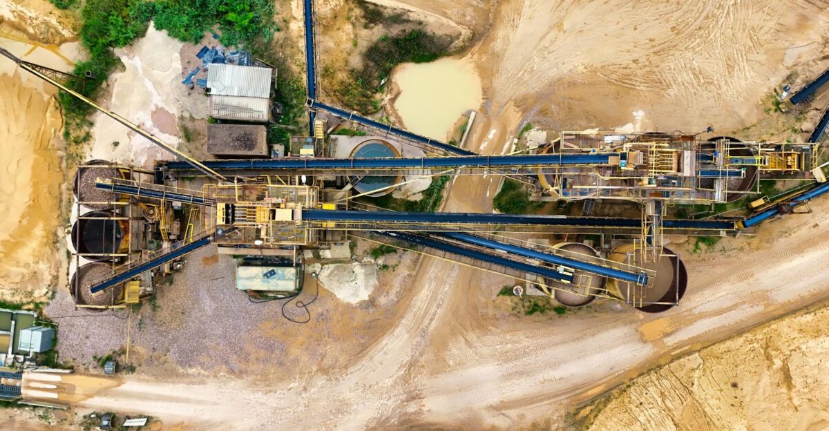 Top-down view of a sprawling industrial mining site featuring heavy machinery and detailed terrain
