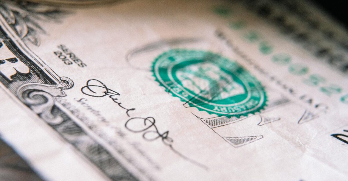 From above closeup one US dollar bill placed on table with front side up