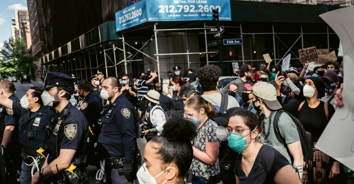 Demonstrators with face masks gather for a protest against racial injustice