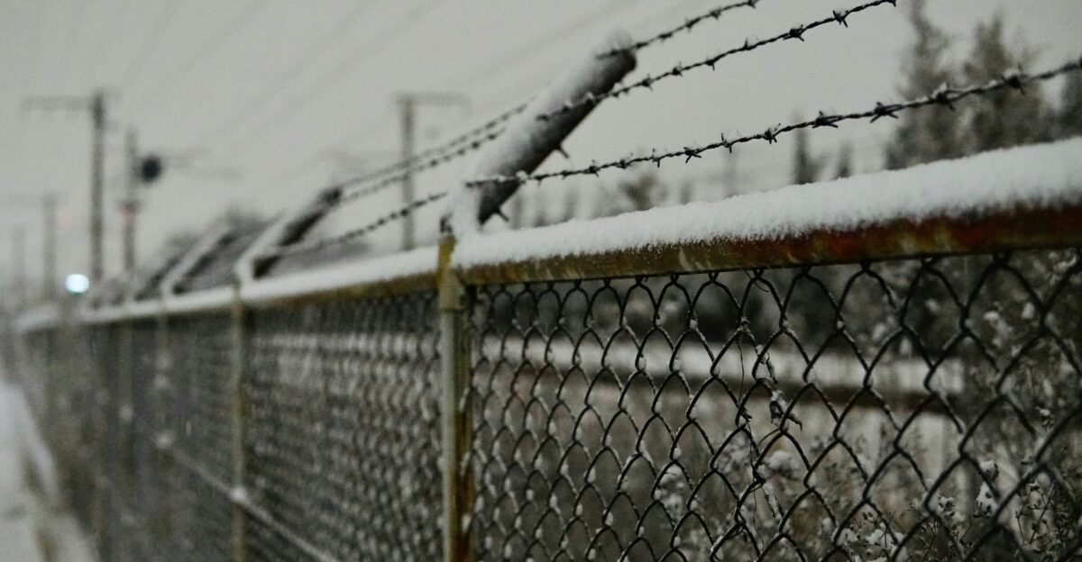 grey metal fence near grey concrete building during daytime