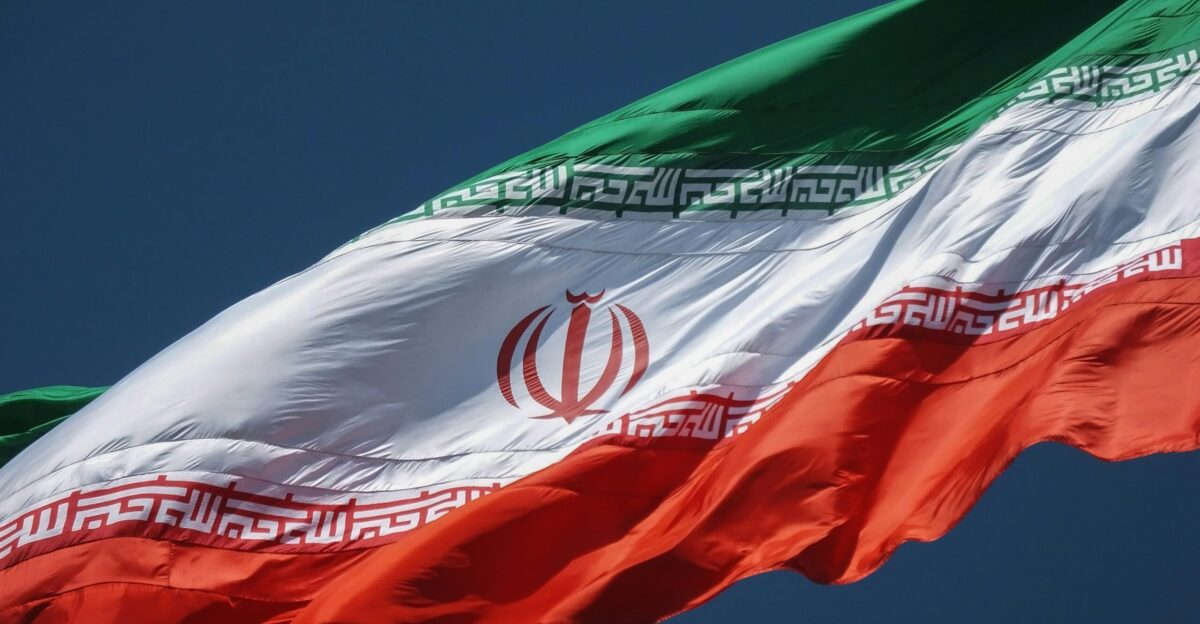 the flag of the country of iraq flying in the sky