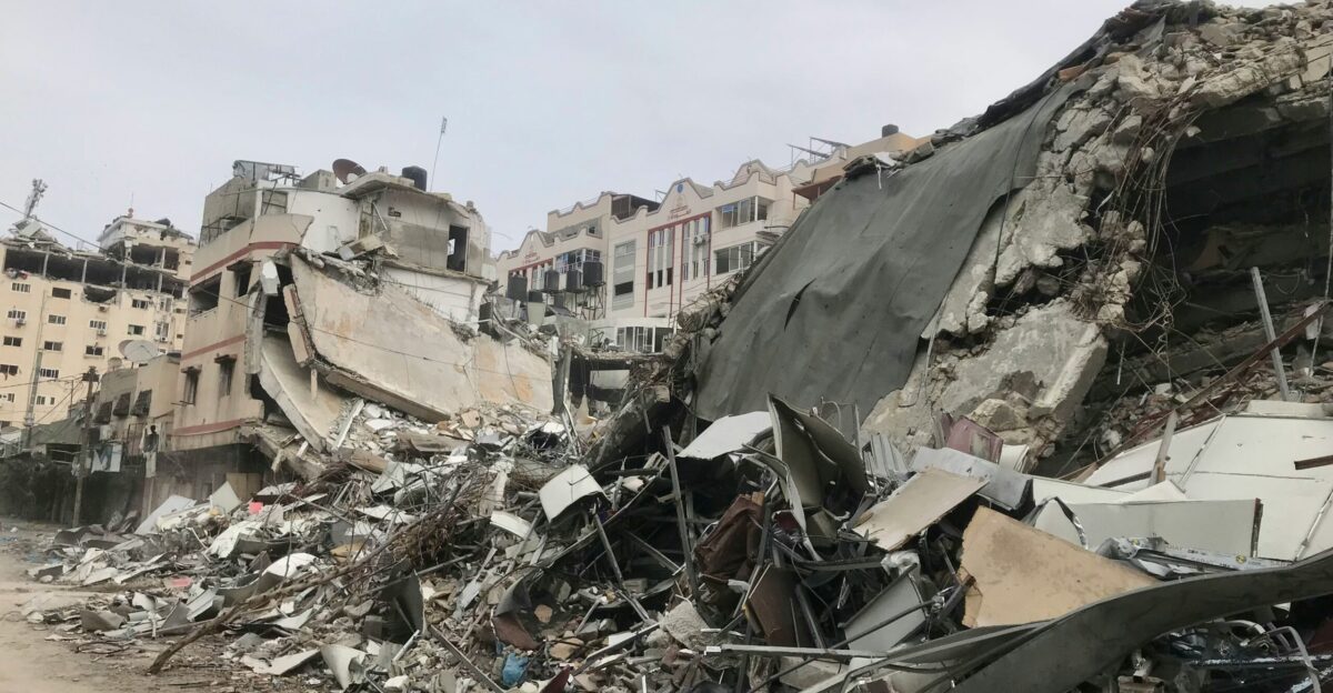 a large pile of rubble next to a dirt road
